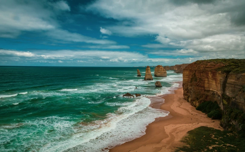 an aerial view of the ocean with a rocky outcropping