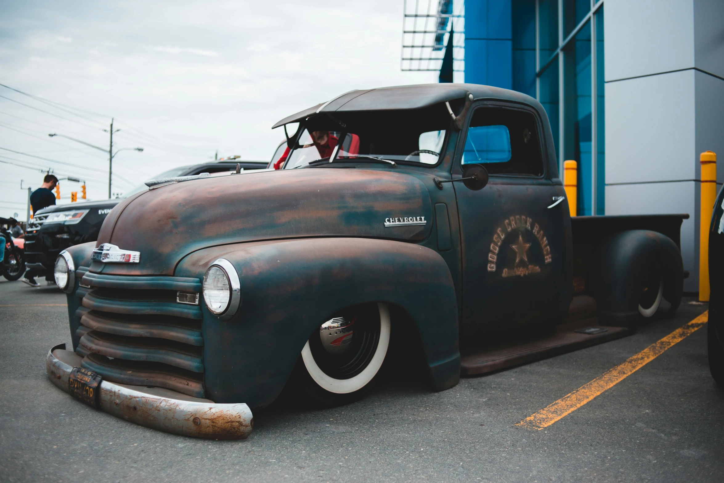 an old pick up truck that is sitting in the parking lot