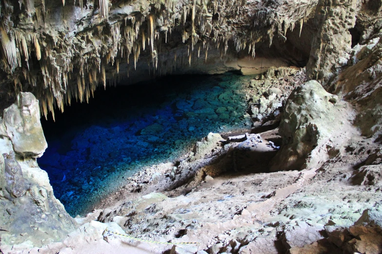 the water is blue inside of a cave