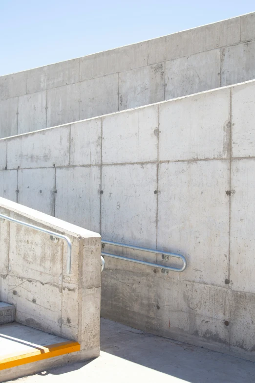 some cement steps with a yellow rail around them