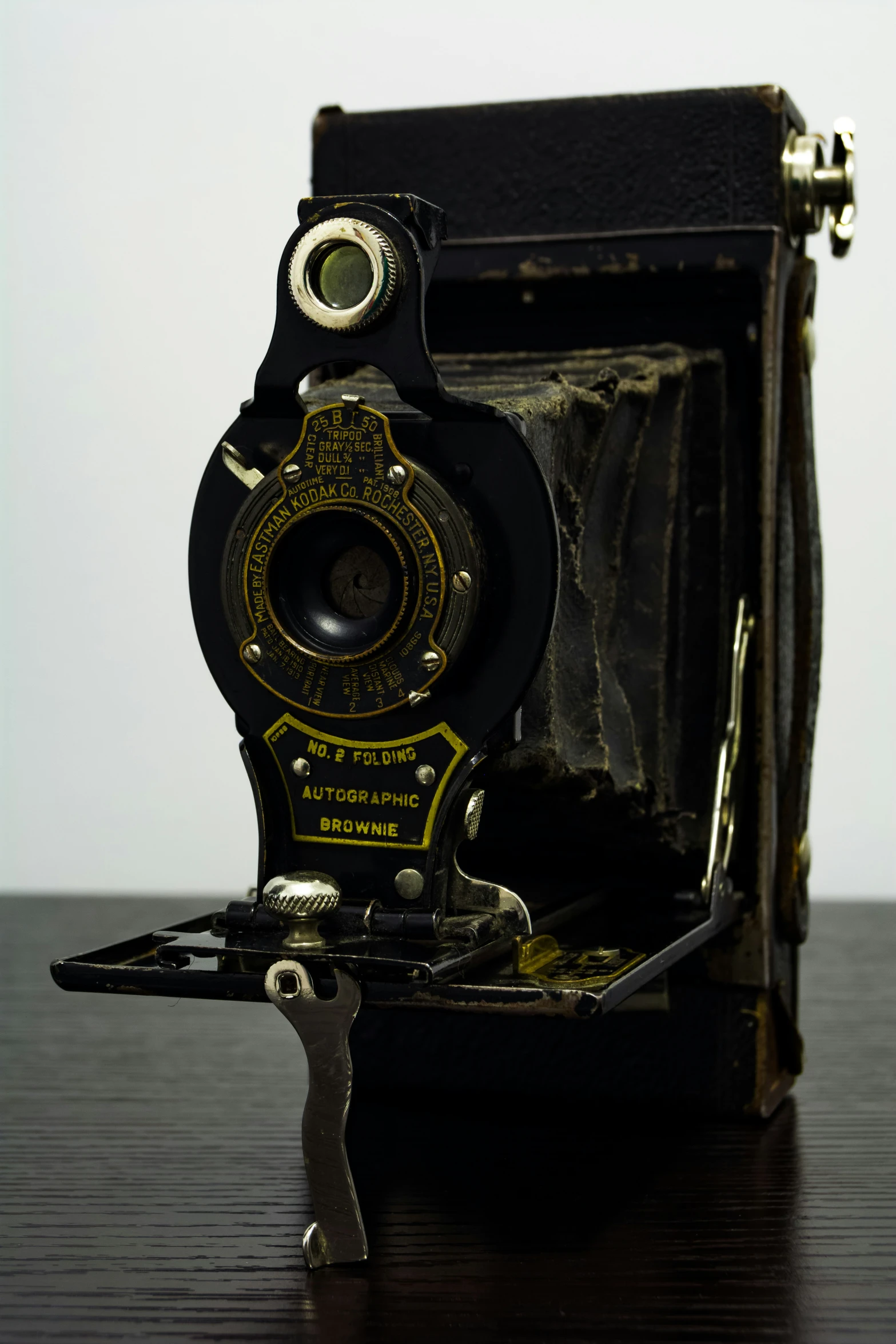 an old looking metal object on a wooden table