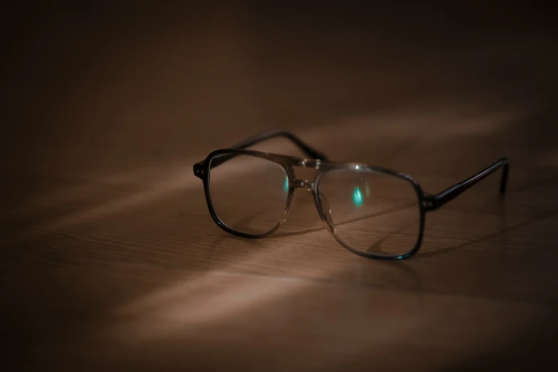 a pair of glasses on a wooden table