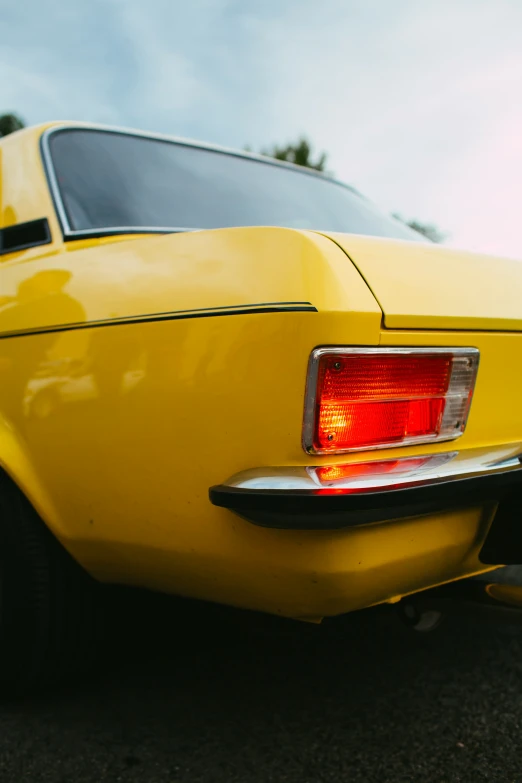 a yellow car on a parking lot