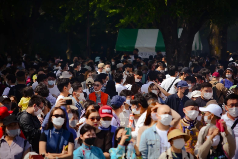 a group of people wearing face masks are seen walking