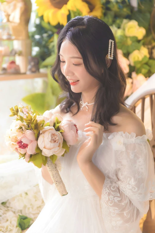 a young woman holding a bridal bouquet