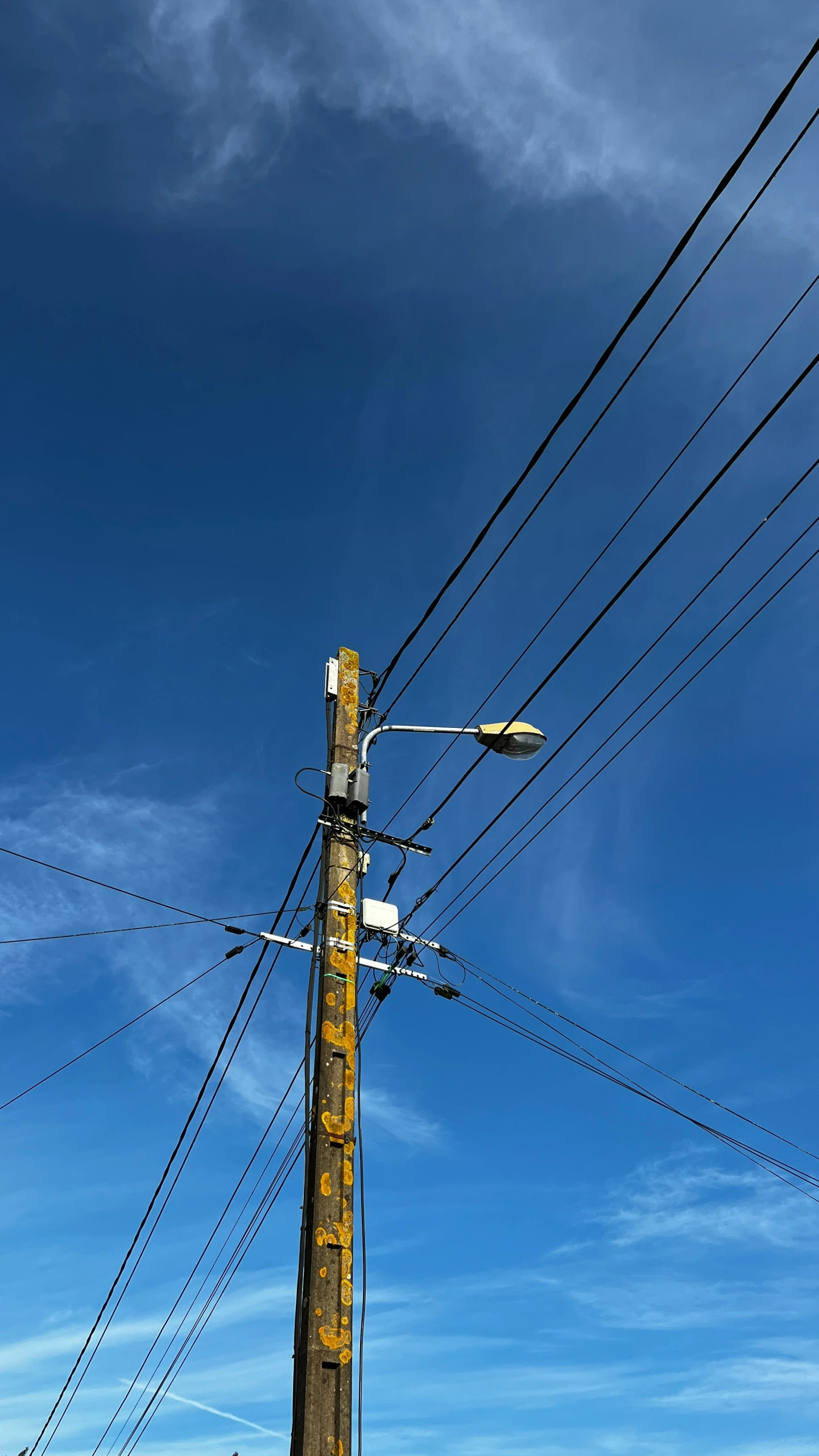 a stop sign and pole in front of a clear blue sky