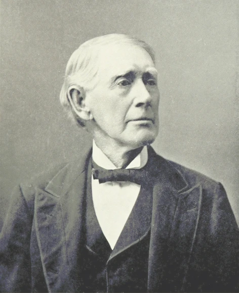an old po of a man wearing a suit and bow tie