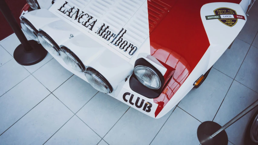 the front end of a car sitting on top of a tile floor