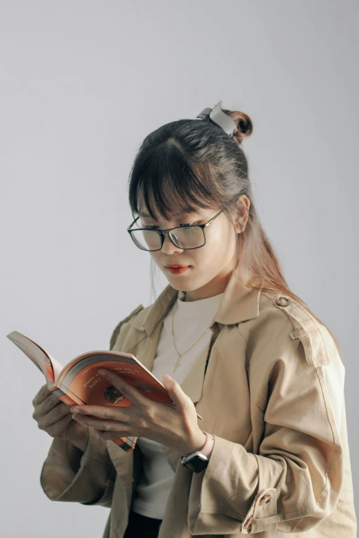 a woman wearing glasses reading a book