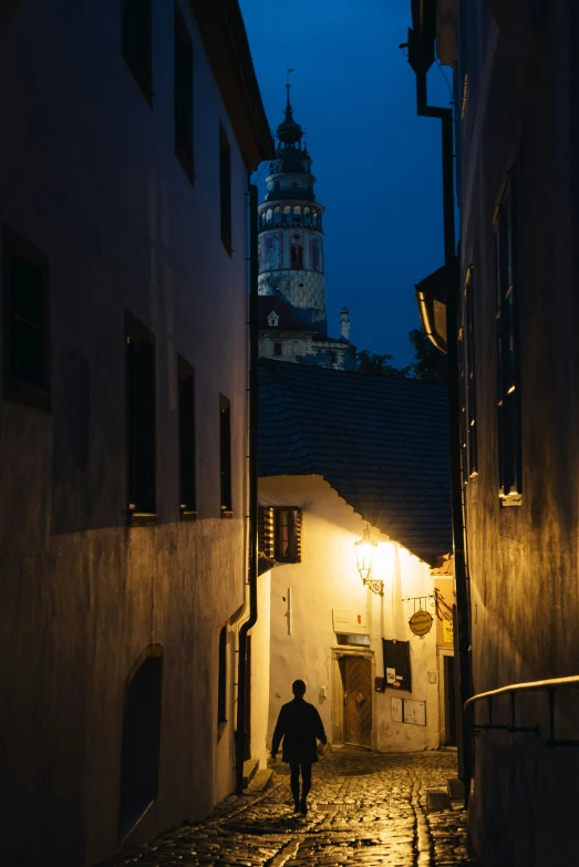 a person walking down a narrow alley way