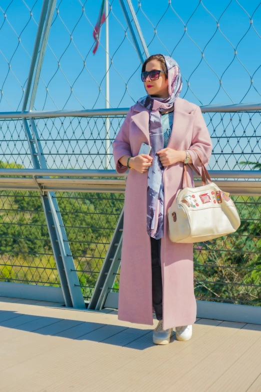 a woman holding a white purse and wearing sunglasses