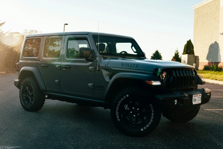 a black jeep parked in front of a tall building