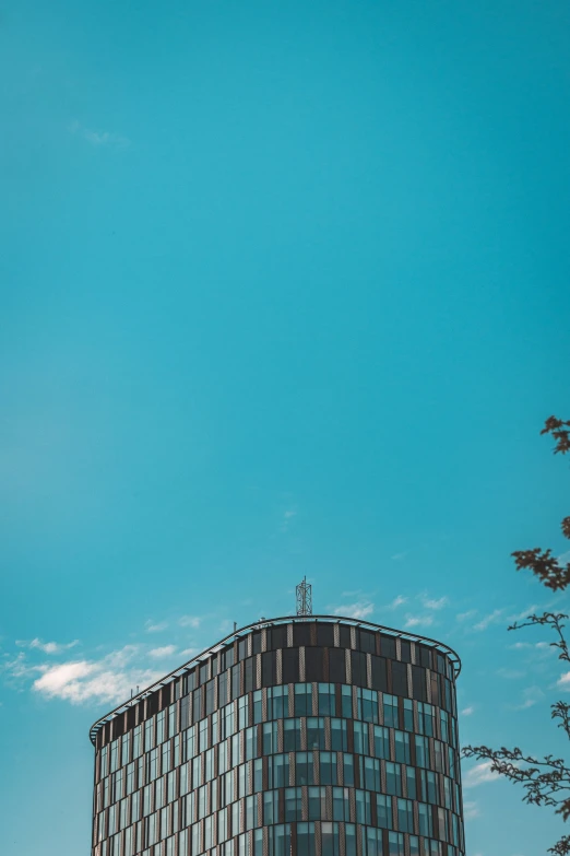 a tall building is standing against a clear blue sky