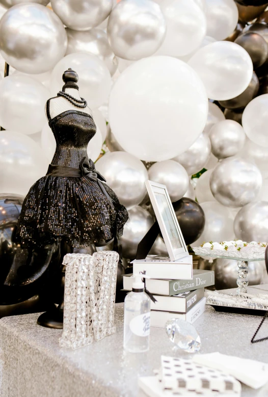 a woman's dress sitting on top of a table next to a box of perfume