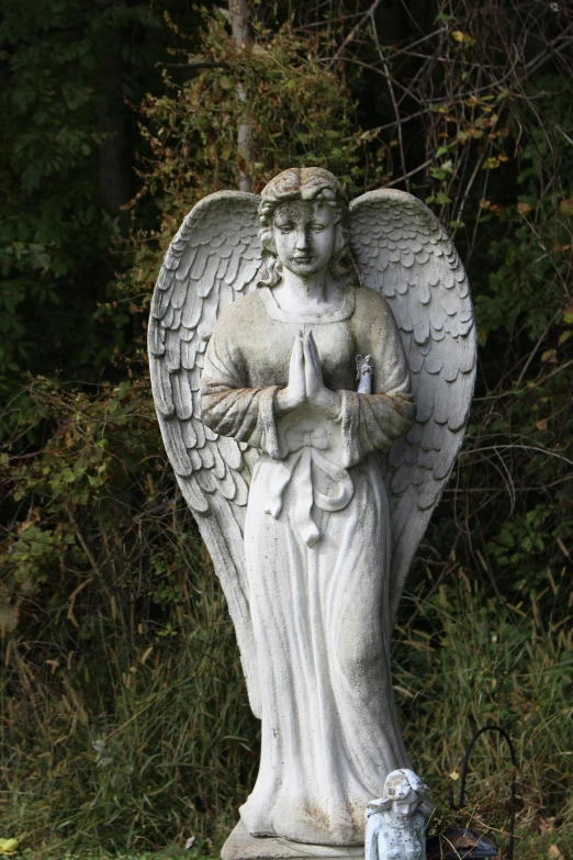 a statue of an angel in a garden
