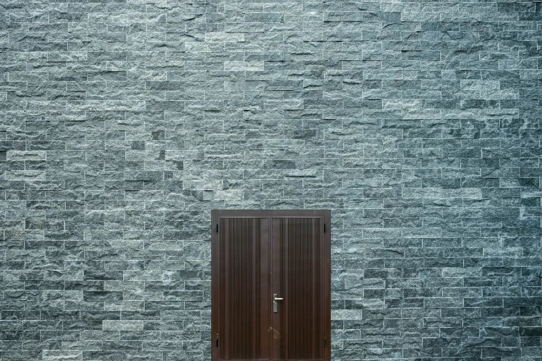 a door is open against a brick wall