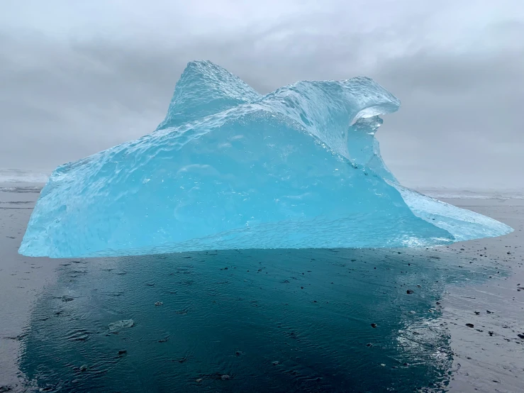 an iceberg floating in the air near the ocean