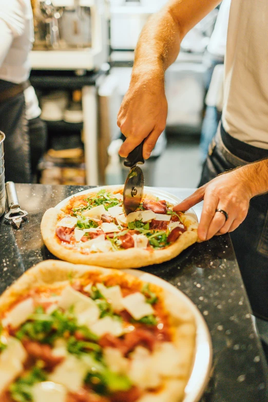 a man  a pizza on a table