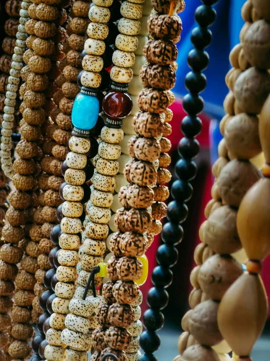 beaded necklaces are hanging on a table
