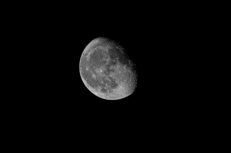 the moon shining in the sky during the night