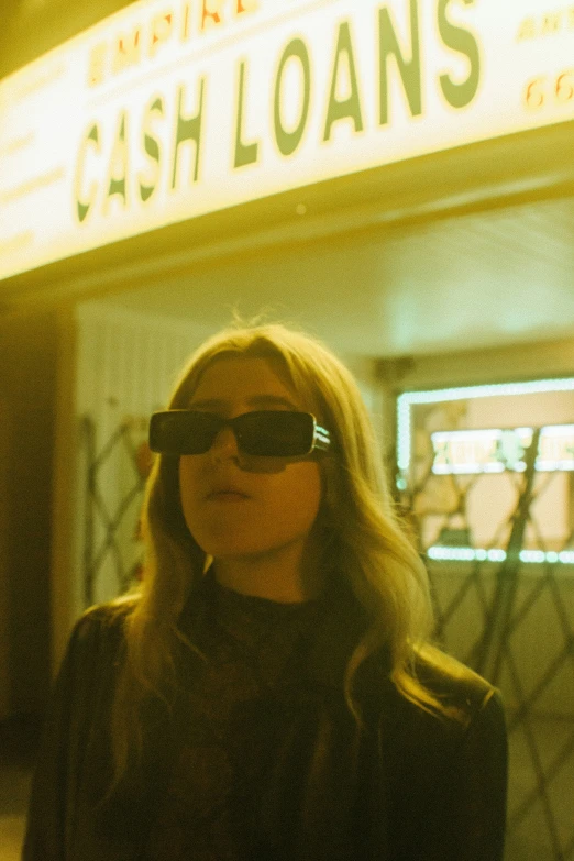 woman standing outside a movie theater wearing blind folded