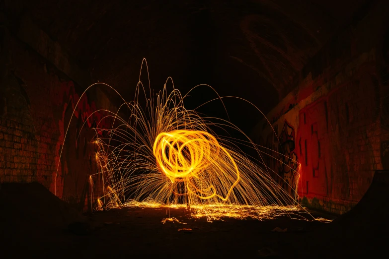 a man standing next to two long exposure fireworks