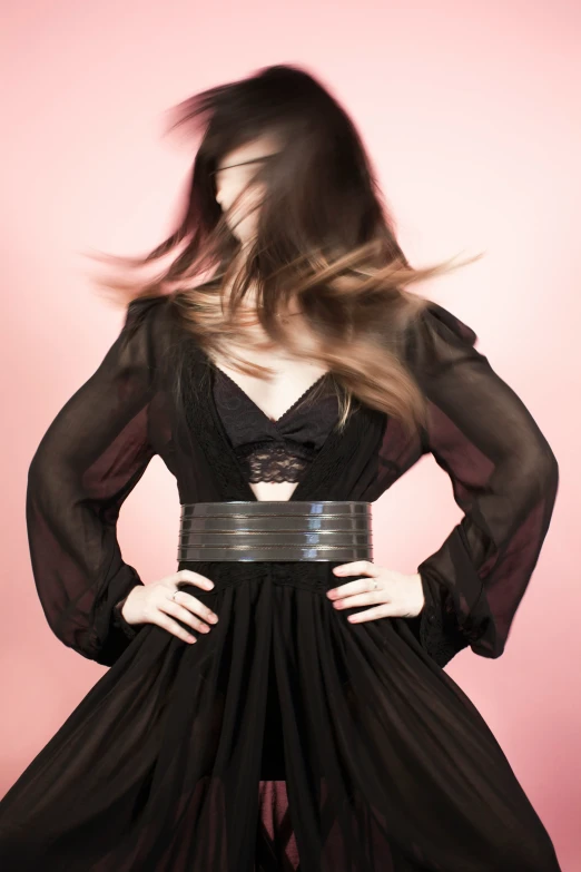 a woman in black dress with long hair and long flowing hair