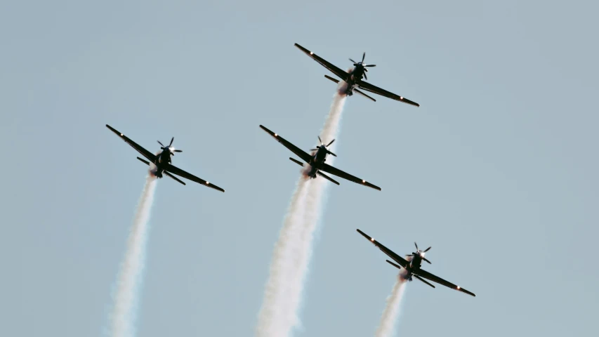 four jets are leaving smoke behind them during the show