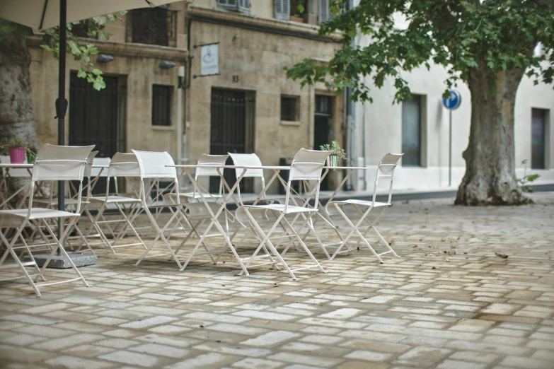 empty chairs and tables sitting on a street