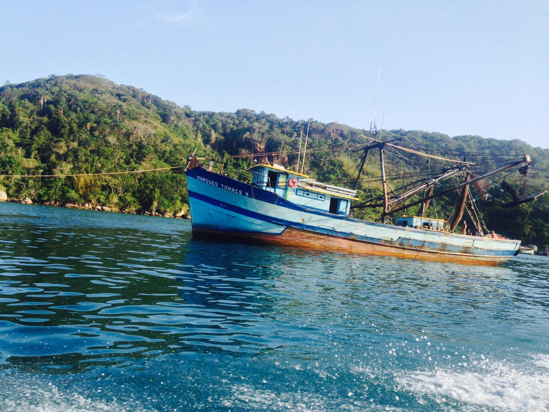 a boat on the water in front of an island