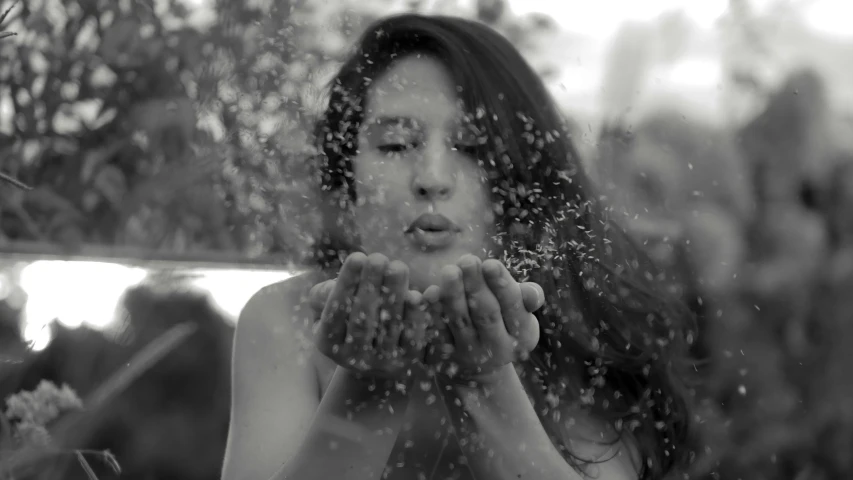 a woman with long hair is holding her hands together