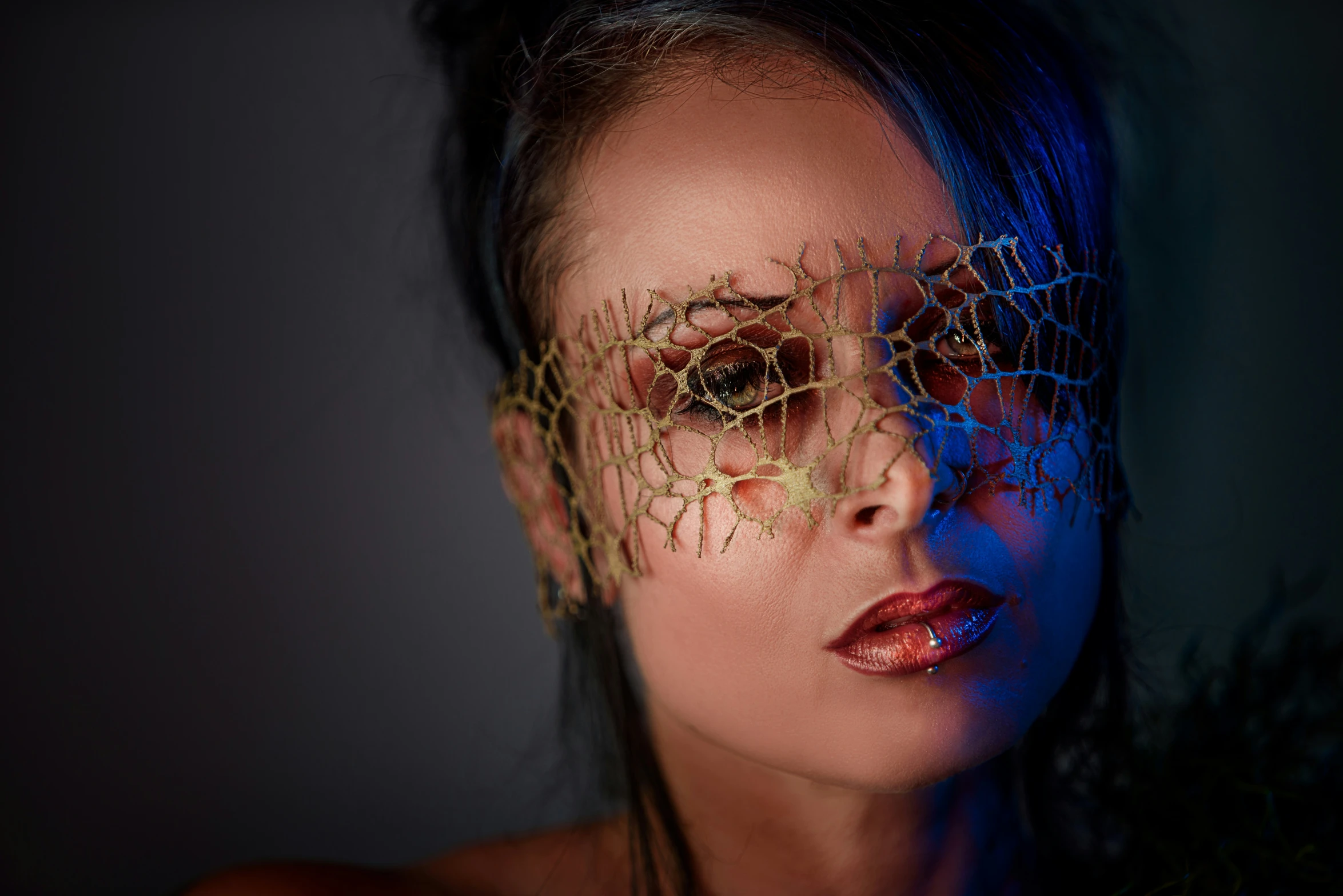 a woman with face art and decorative head covering