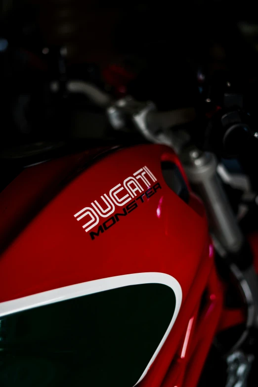 the side view of a red motorcycle with the name trusue