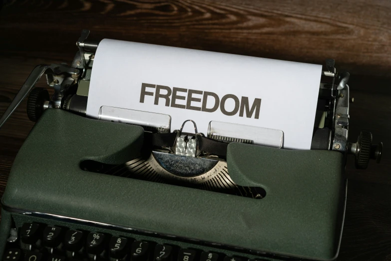 an old fashioned typewriter with the word'freedom'on it