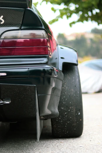 a close up of the rear bumper and tail end of a modern sports car