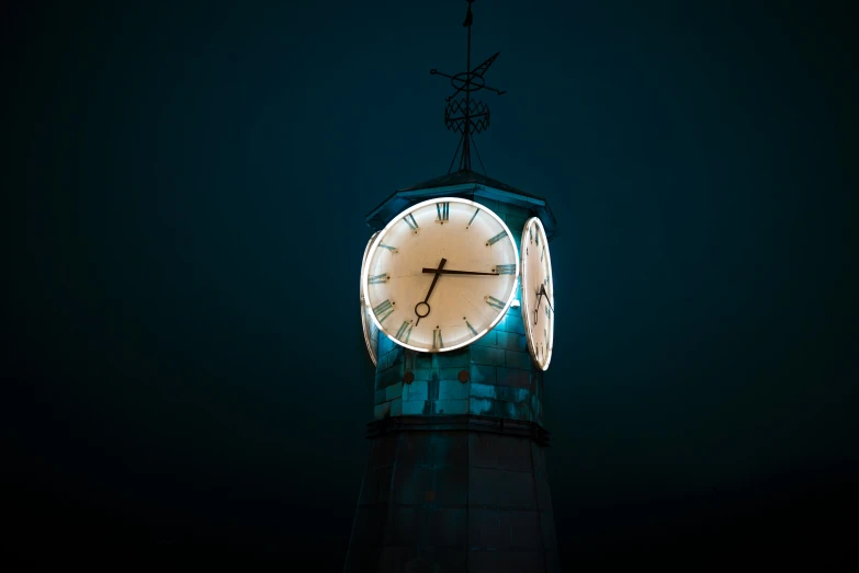 an illuminated clock tower lit up on a dark night