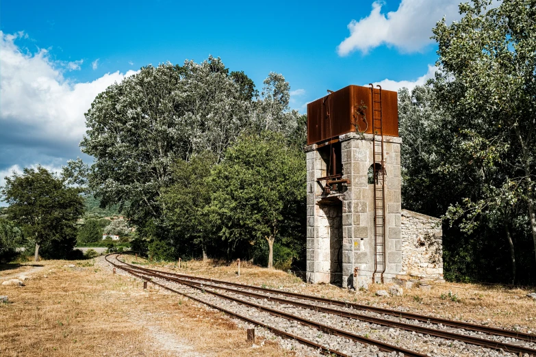 a train track near an old tower