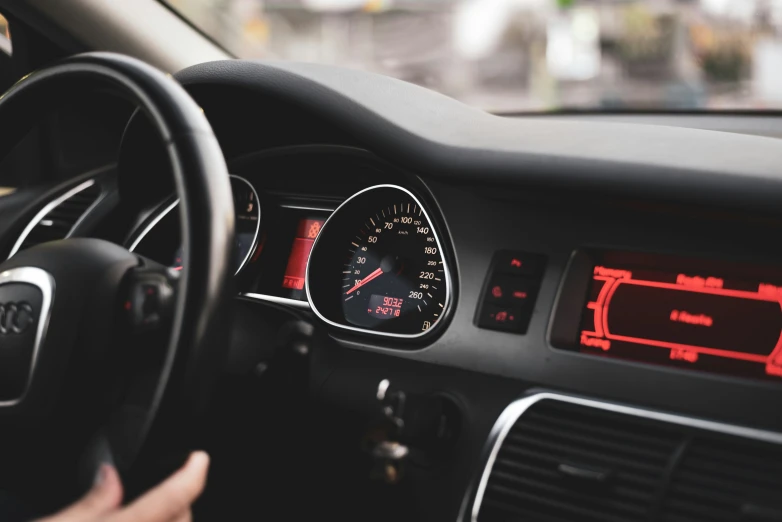 a car with various dash lights, steering wheel and dashboard