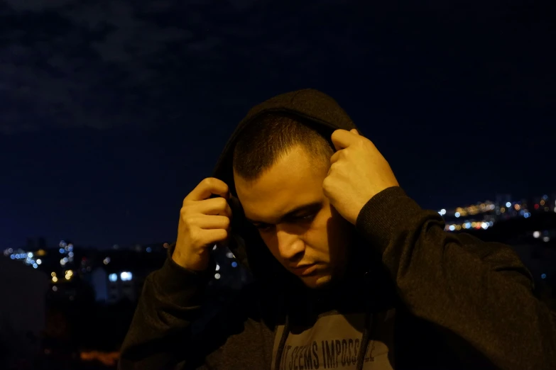a man covering his ears and looking away from the camera