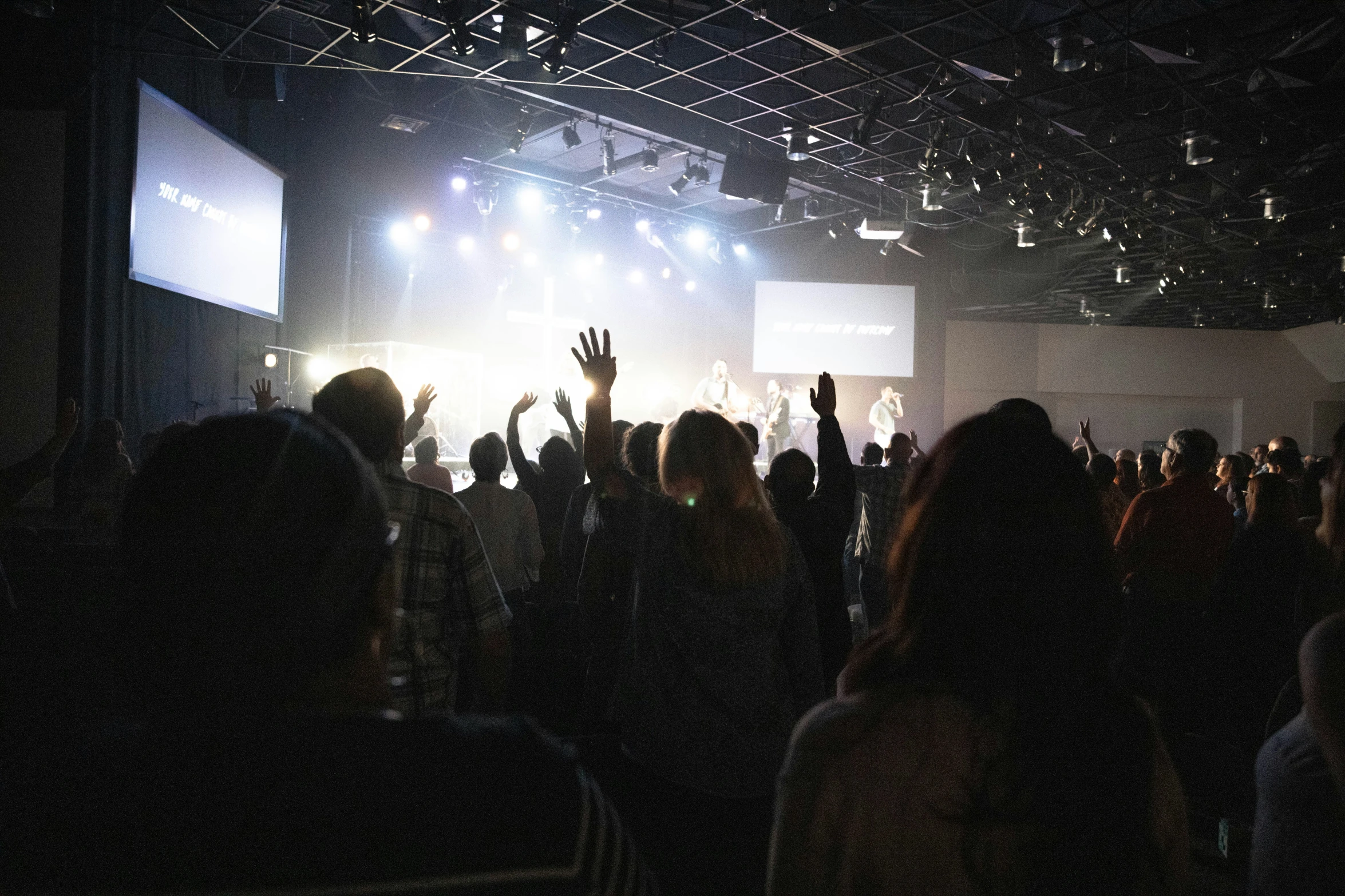 the large crowd has their hands up to see an image