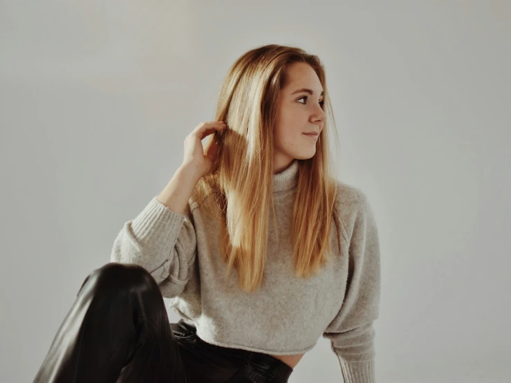 woman with long blonde hair wearing black leather pants