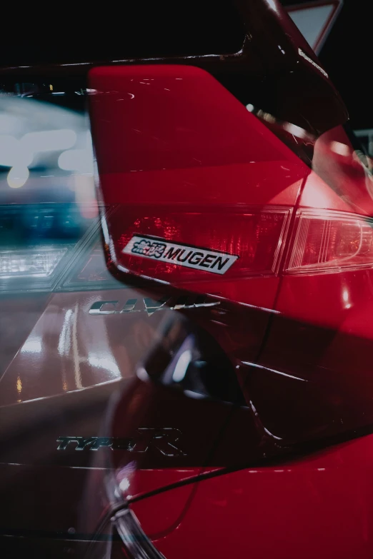 an elegant red car with a sticker that says veggies