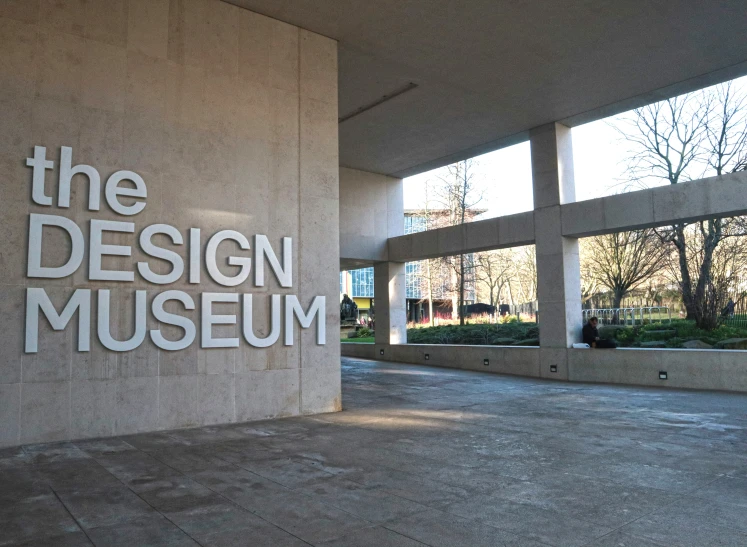 a sign that says the design museum is displayed outside of a building