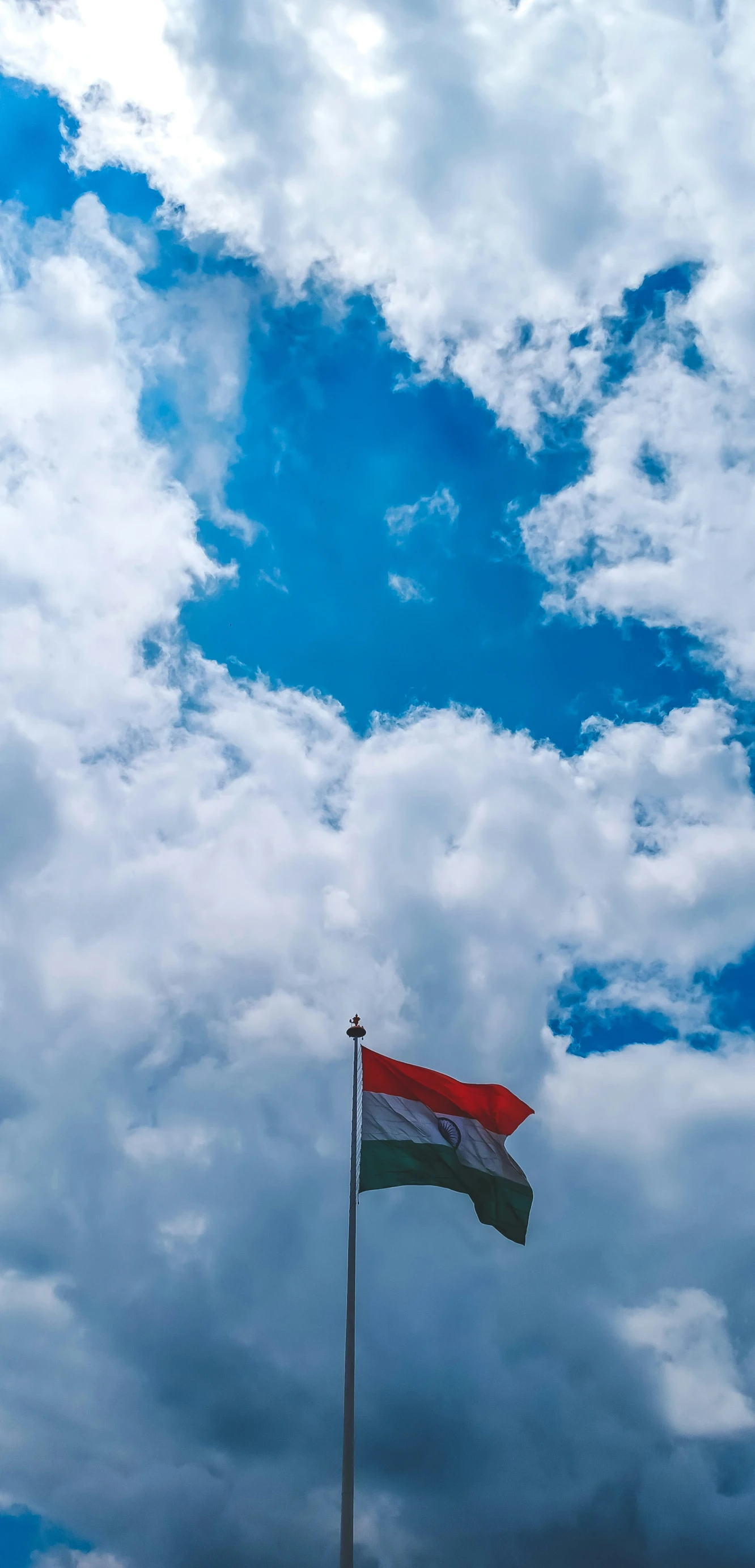 a red white and blue flag blowing in the wind