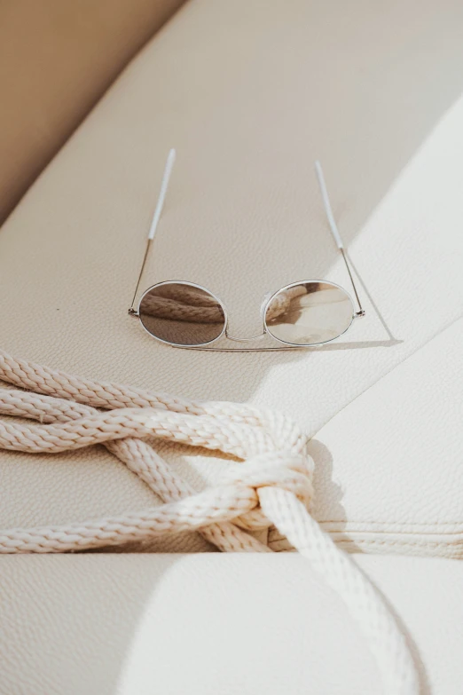 an eyeglass resting on top of a white surfboard