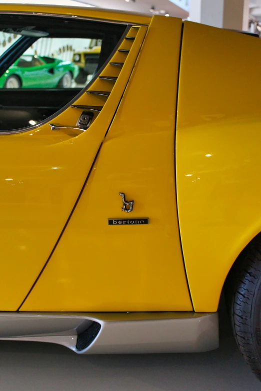 a bright yellow car is sitting parked in a garage