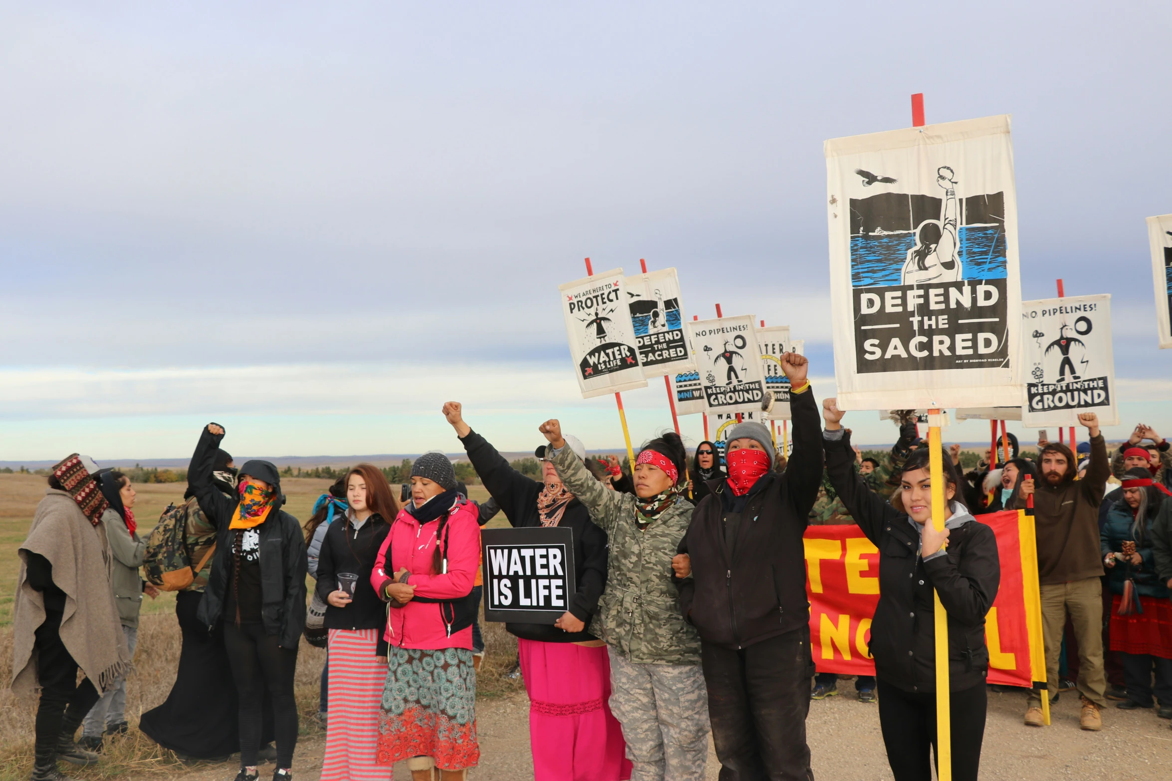 a group of people holding protest signs with banners