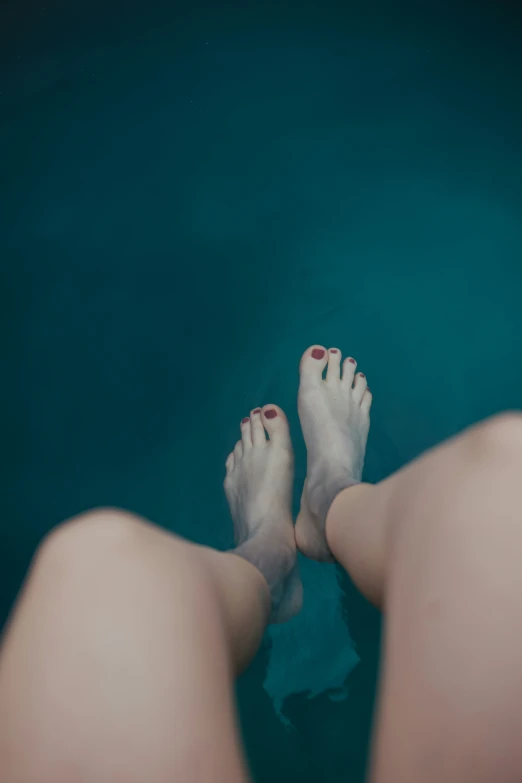 legs above the water of a body of water