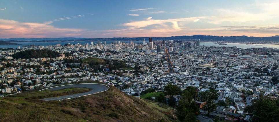 a city skyline sits upon a hill top