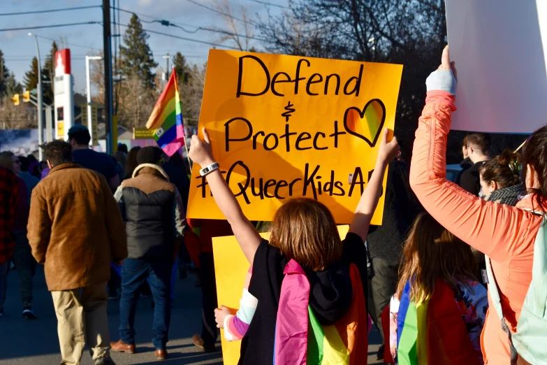 a group of people on the street holding up a sign